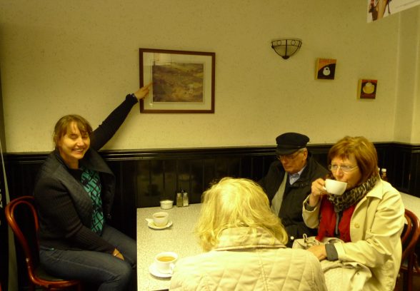 Tour leader Vanessa showing the photo of Carr's Papers in the local cafe
